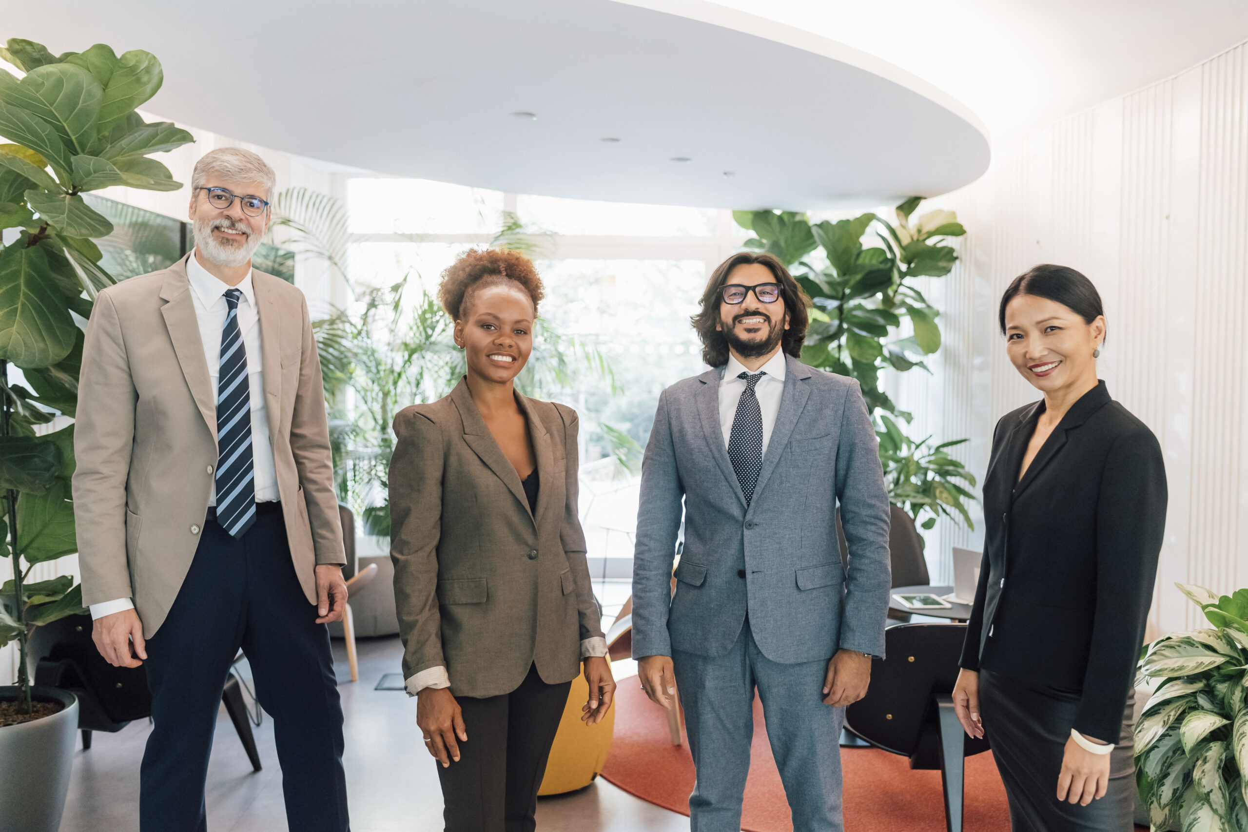Italy, Portrait of smiling business people standing in creative studio